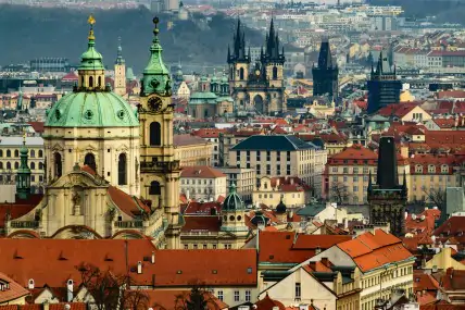 Prague skyline with St. Nicholas Church's green dome and the spires of the Church of Our Lady before Týn