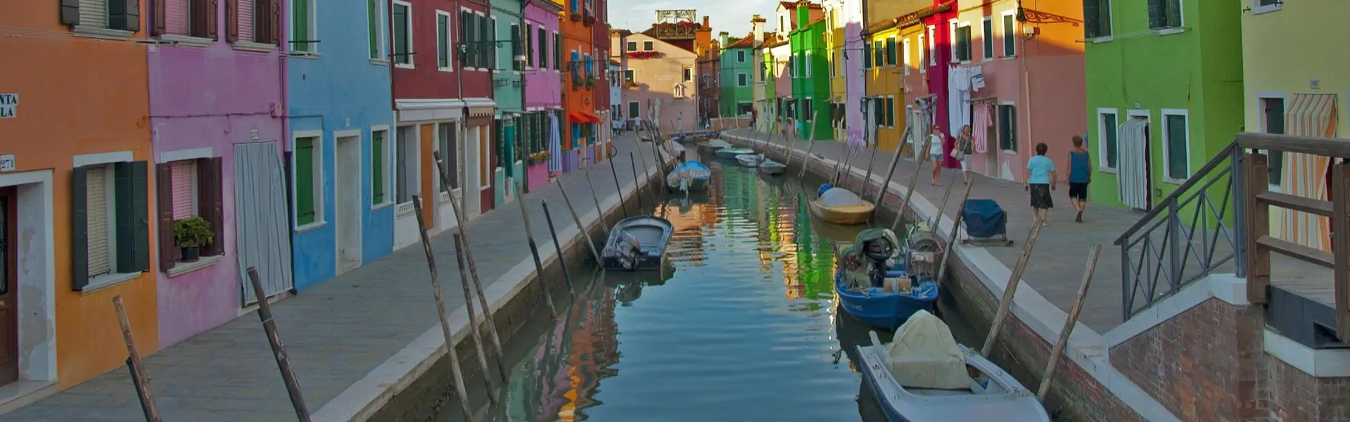 Colorful houses lining a canal on Burano island near Venice